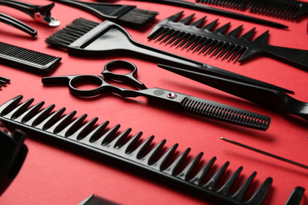 Different hairdresser's tools on red background, closeupの写真素材
