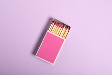 Matches in box on violet background, top view. Mockup for designの写真素材