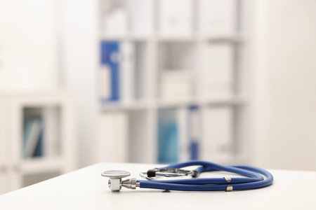 Doctor's workplace. Stethoscope on white table in medical office, closeup. Space for textの写真素材