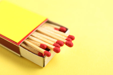 Matches in box on yellow background, closeupの写真素材