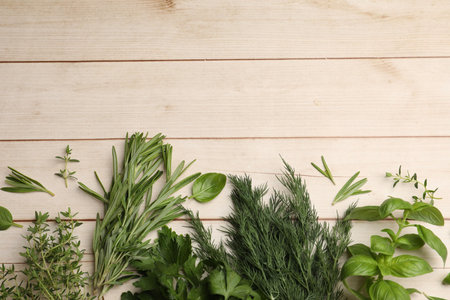 Different fresh herbs on white wooden table, flat lay. Space for textの写真素材