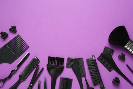 Different hairdresser's tools on violet background, flat lay. Space for textの写真素材