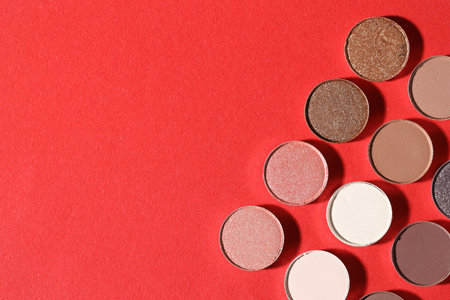 Beautiful eyeshadow refill pans on red background, flat lay. Space for textの写真素材