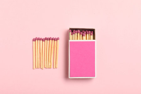 Matches and box on pink background, flat lay. Mockup for designの写真素材