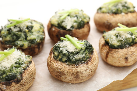 Tasty stuffed mushrooms served on white wooden table, closeupの写真素材