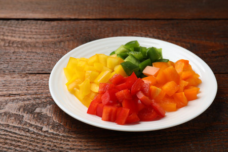 Cut colorful bell peppers on wooden table, closeupの写真素材