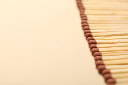 Matches with brown heads on beige background, closeup. Space for textの写真素材