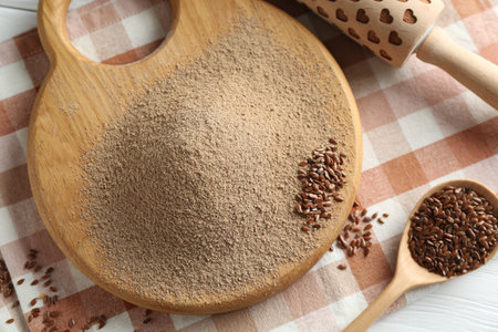 Flaxseed flour, rolling pin and spoon on table, closeupの写真素材