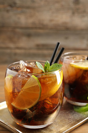 Refreshing Cuba libre cocktail with mint on wooden table. Space for textの写真素材