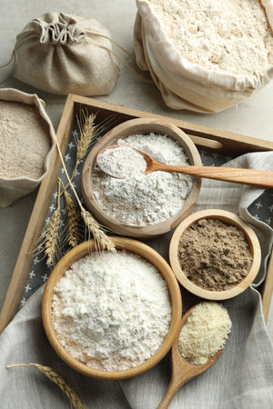 Different types of flour on light grey table, flat layの写真素材