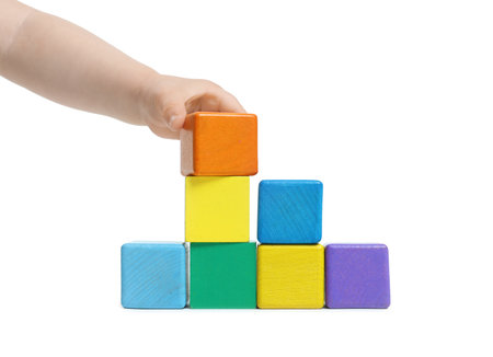 Child playing with colorful cubes on white background, closeupの写真素材