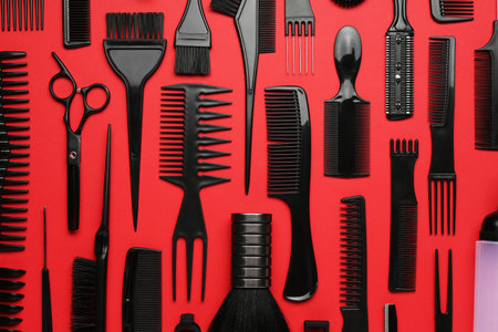 Different hairdresser's tools on red background, flat layの写真素材