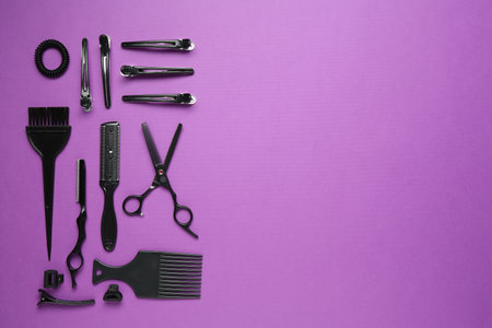 Different hairdresser's tools on violet background, flat lay. Space for textの写真素材