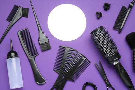 Different hairdresser's tools on purple background, flat layの写真素材
