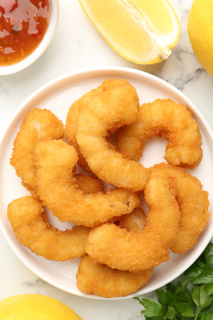 Tasty tempura shrimps served on white marble table, flat layの写真素材