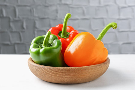 Ripe colorful bell peppers on white tableの写真素材