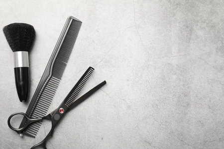 Different hairdresser's tools on grey table, flat lay. Space for textの写真素材