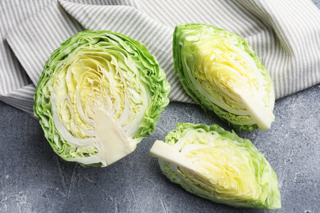 Pieces of fresh cabbage on grey table, flat layの写真素材