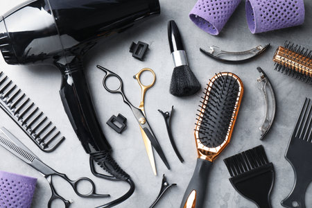 Different hairdresser's tools on grey table, flat layの写真素材
