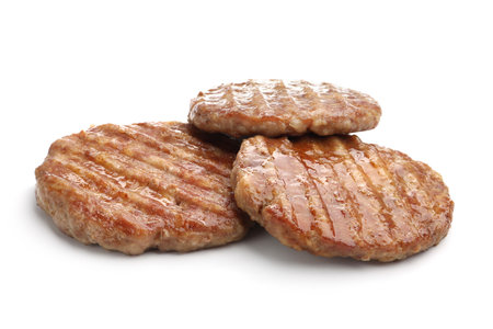 Three delicious hamburger patties isolated on whiteの写真素材