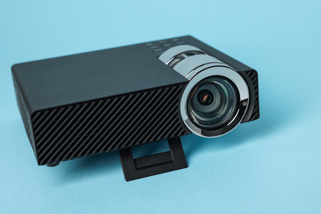 Modern video projector on light blue background, closeupの写真素材