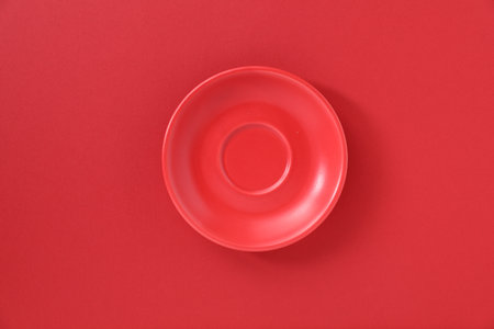 One empty plate on red background, top viewの写真素材