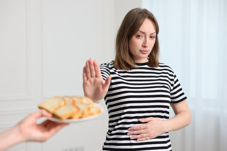 Gluten free diet. Woman refusing from bread indoorsの写真素材