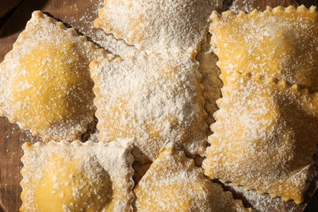 Uncooked ravioli on wooden table, top viewの写真素材