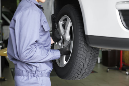 Mechanic changing tire at car service, closeupの写真素材