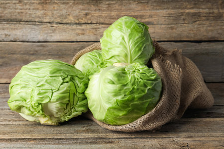 Many whole fresh cabbages on wooden tableの写真素材