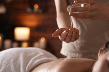 Woman receiving back massage with oil in spa salon, closeupの写真素材