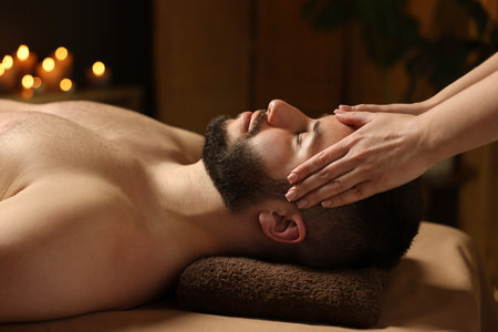 Man receiving relaxing massage in spa salonの写真素材