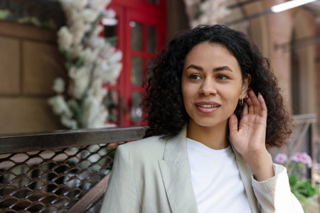 Portrait of smiling Latin American woman outdoors. Space for textの写真素材
