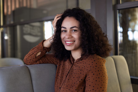 Portrait of smiling Latin American woman in cafe