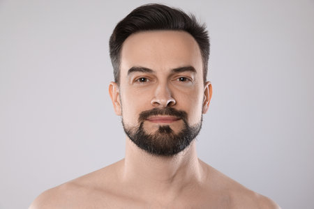 Portrait of handsome man on grey background, closeupの写真素材