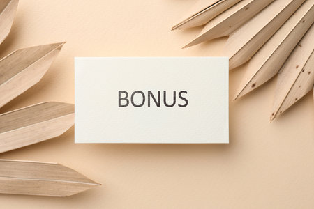 Bonus card and decorative plants on beige background, flat layの写真素材