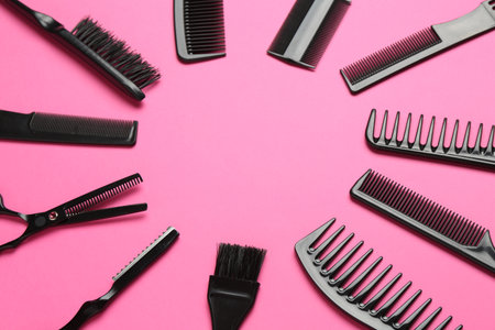 Frame of different hairdresser's tools on pink background, flat lay. Space for textの写真素材