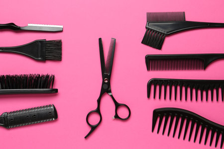 Different hairdresser's tools on pink background, flat layの写真素材