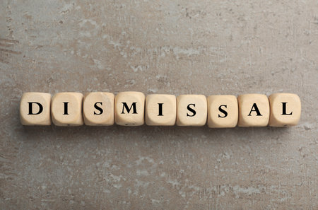 Word Dismissal made of wooden cubes on grey textured background, top viewの写真素材