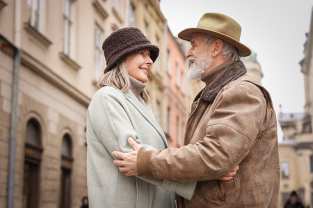 Happy senior couple walking on city streetの写真素材