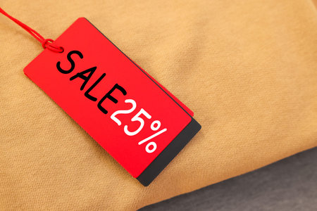 Red Sale tag on clothing, top view