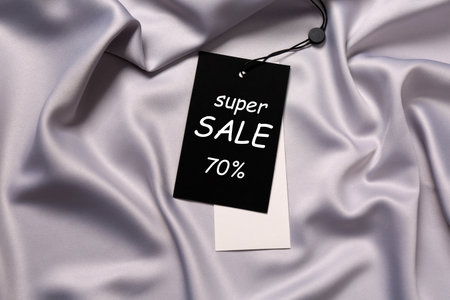 Black Sale tag on silk skirt, top viewの写真素材
