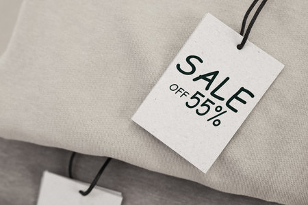 White Sale tag on clothing, top viewの写真素材