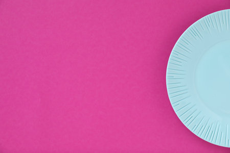 One empty plate on pink background, top view. Space for textの写真素材
