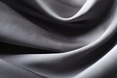 Crumpled grey silk fabric as background, closeup