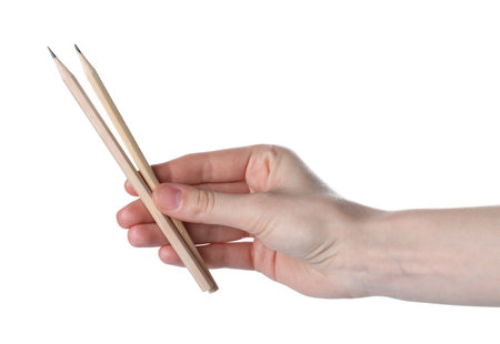 Woman with graphite pencils on white background, closeupの写真素材