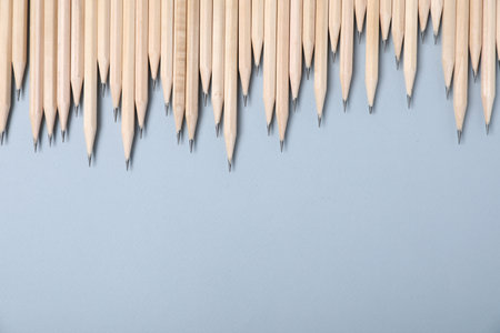 Many graphite pencils on grey background, flat lay. Space for textの写真素材