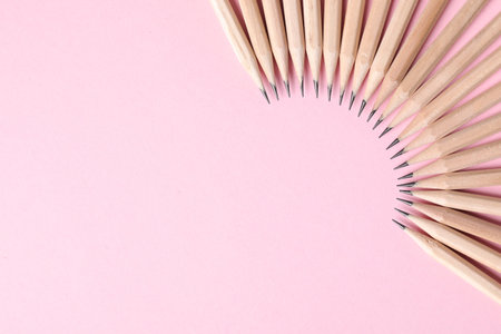 Many graphite pencils on pink background, flat lay. Space for textの写真素材