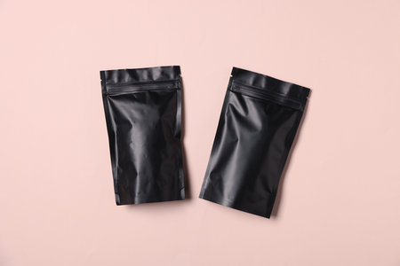 Zipper stand-up pouches on pink background, top view. Mockup for design