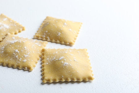 Uncooked ravioli on white table, closeup view. Space for textの写真素材